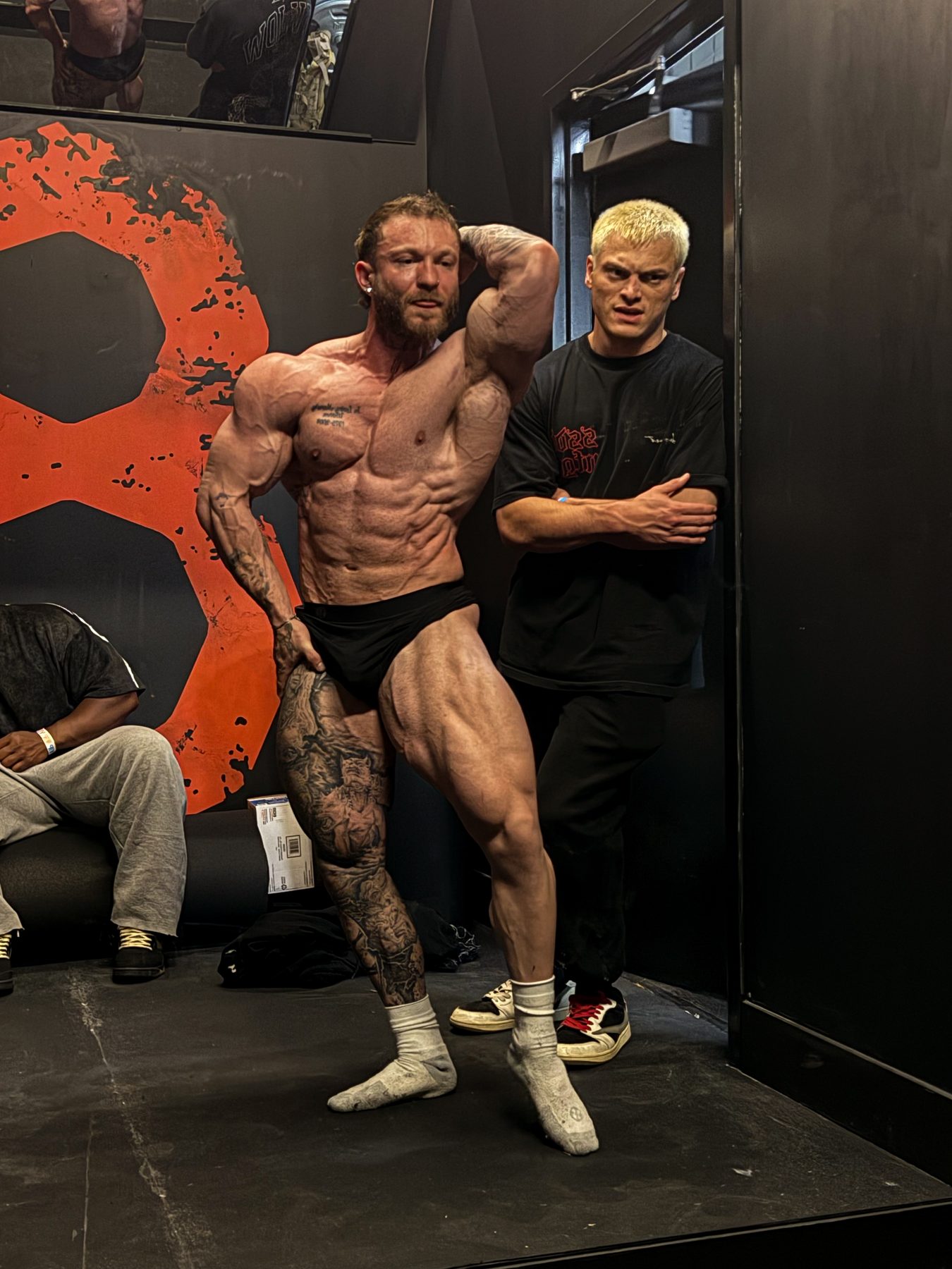Jake coaching an athlete through a pose backstage